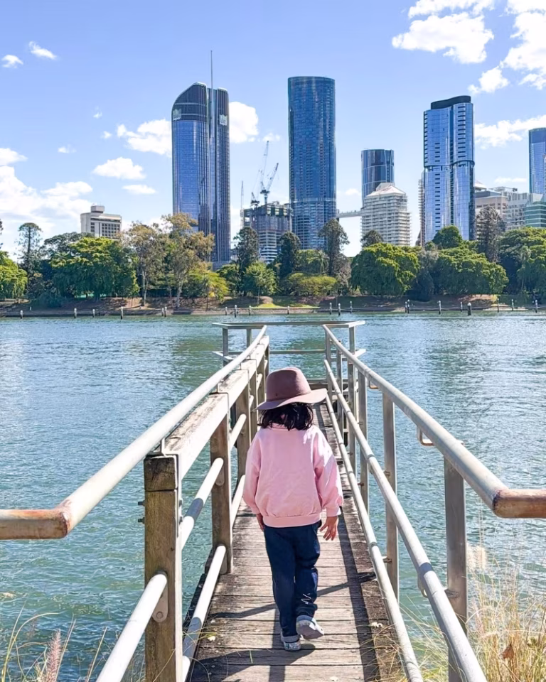 Child walking the boardwalk towards the viewing deck near Riverlife at Kangaroo Point Cliffs Lookout