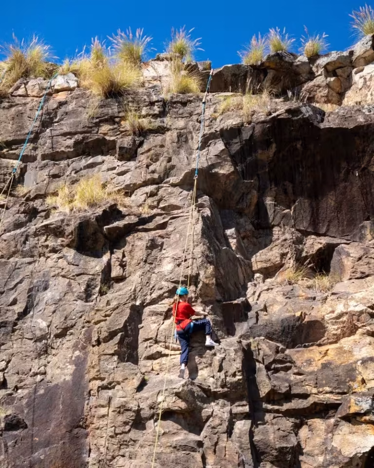 Rock climber on the cliff face at Kangaroo Point Cliffs Lookout