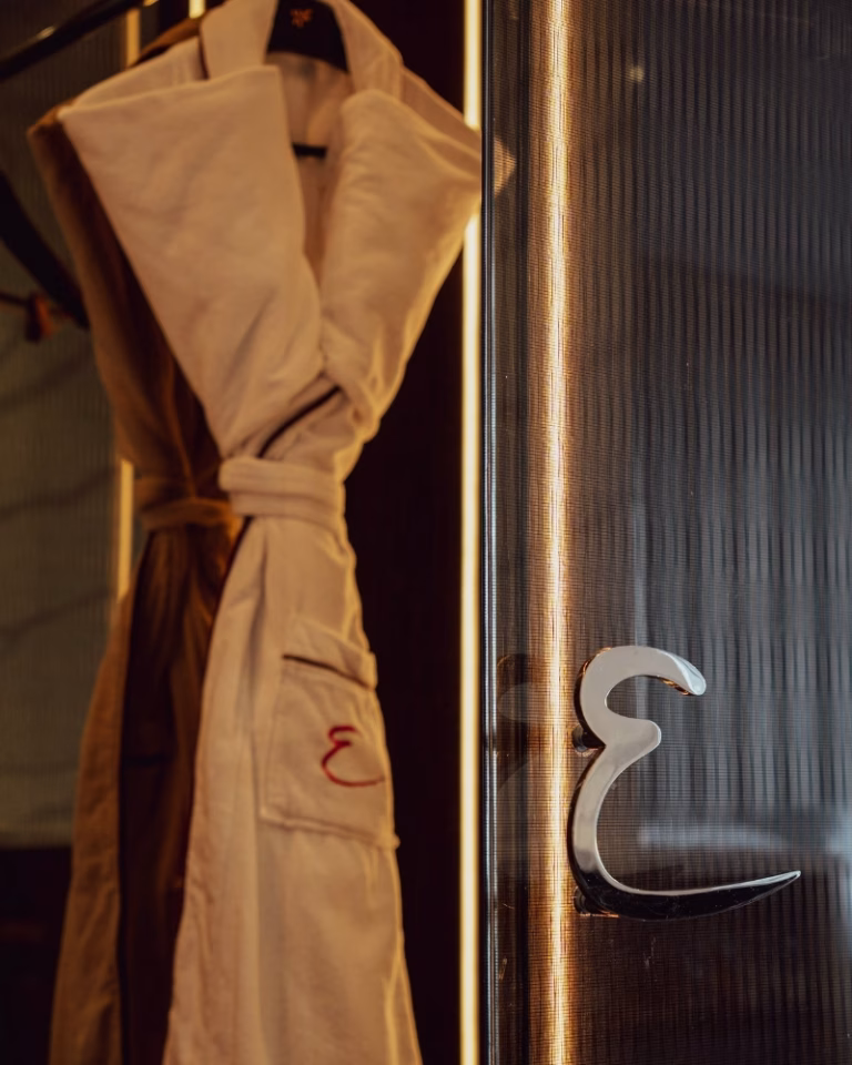 Emporium robes hanging in the River King Suite at Emporium Hotel South Bank