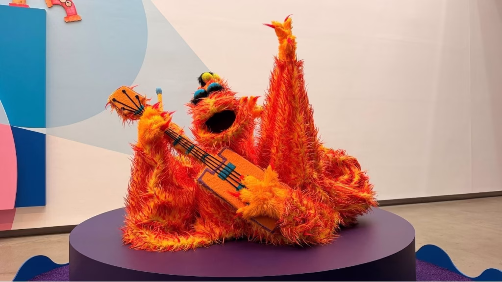A Firey puppet from Labyrinth holding a guitar, on display at the Jim Henson exhibition, GOMA