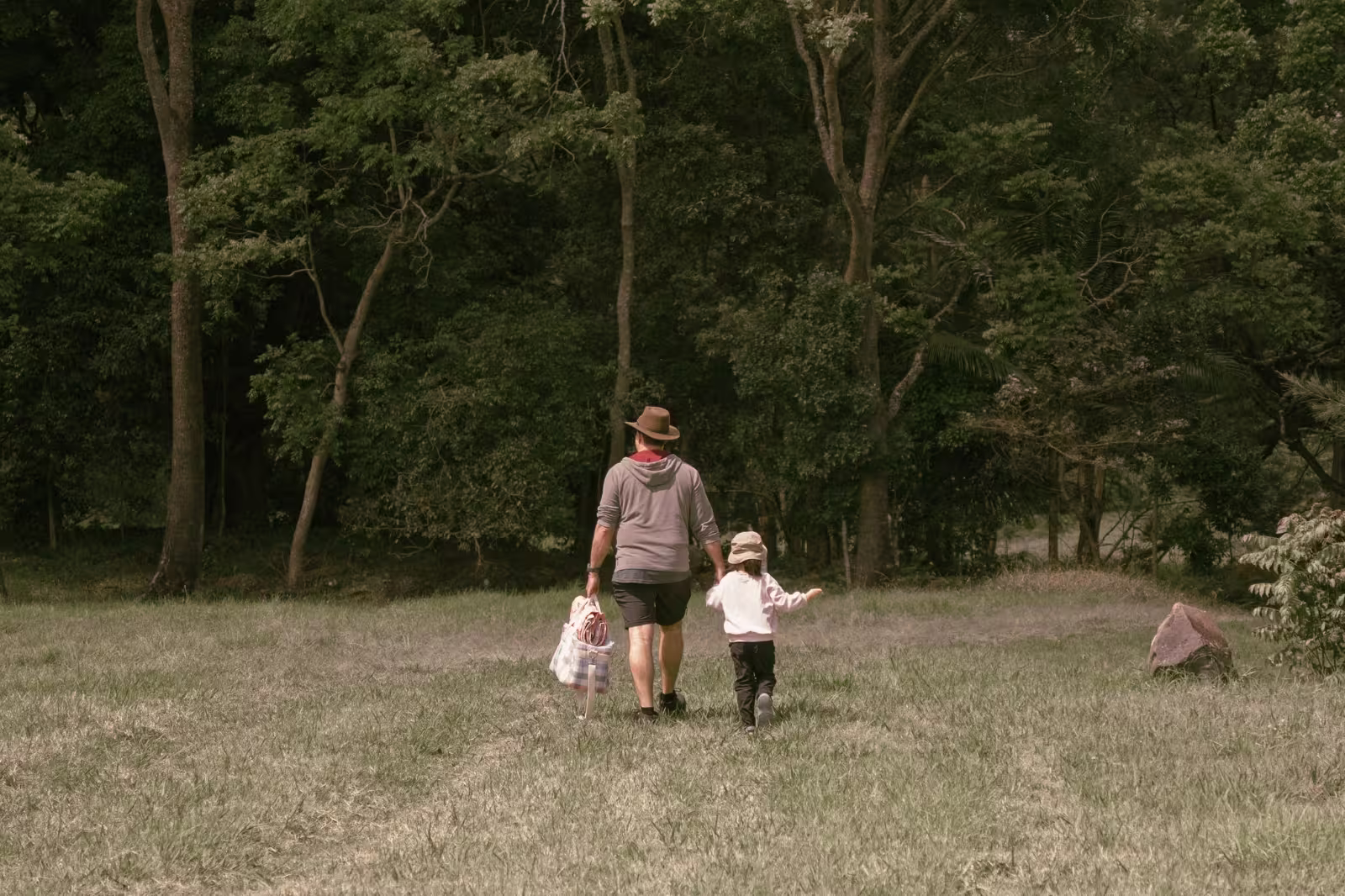 Father and daughter walking beside the creek at the Albert River Right Branch